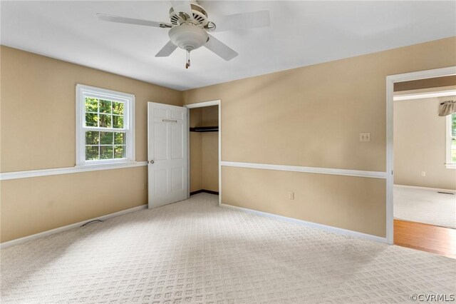 unfurnished bedroom featuring light carpet and ceiling fan