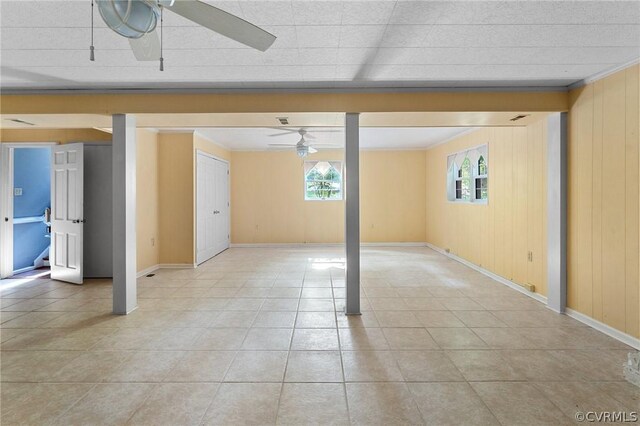 tiled empty room with ceiling fan