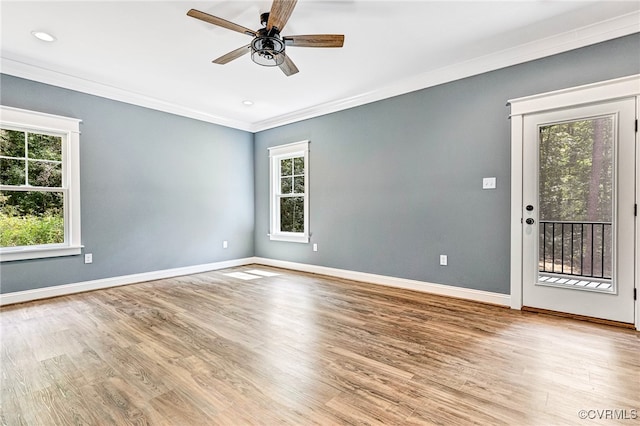 empty room with ceiling fan, light hardwood / wood-style flooring, and crown molding