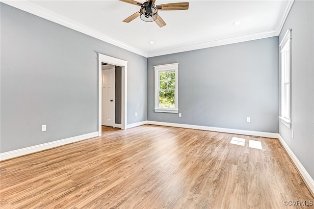 empty room featuring ceiling fan, light hardwood / wood-style flooring, and ornamental molding