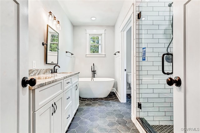 full bathroom with vanity, shower with separate bathtub, and toilet