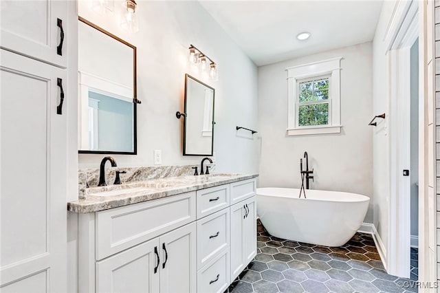 bathroom with vanity and a washtub