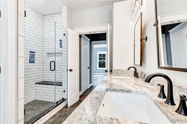 bathroom with vanity and a shower with shower door