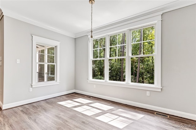 unfurnished room featuring light hardwood / wood-style floors and ornamental molding