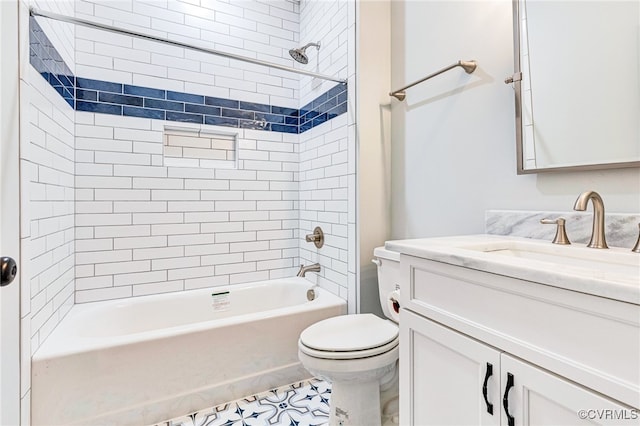 full bathroom featuring tiled shower / bath, vanity, tile patterned flooring, and toilet