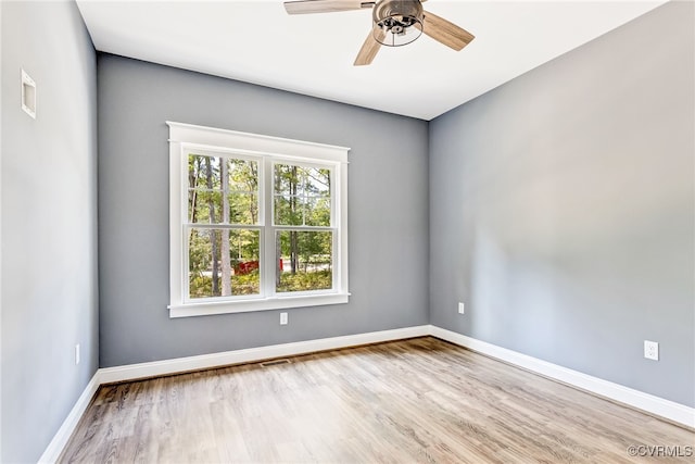 unfurnished room with ceiling fan and wood-type flooring