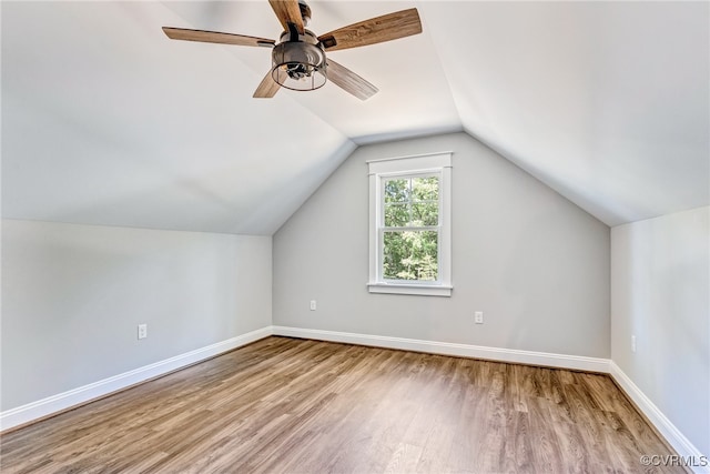 additional living space featuring vaulted ceiling, ceiling fan, and hardwood / wood-style flooring