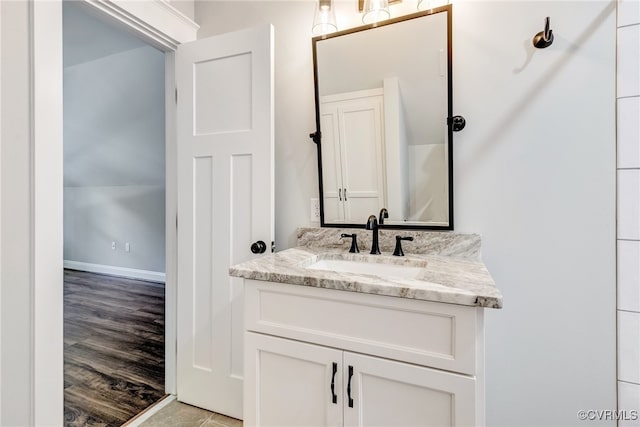 bathroom with hardwood / wood-style floors and vanity