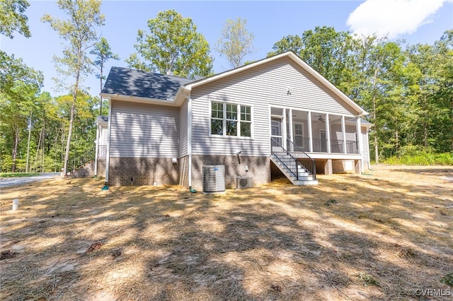 rear view of property featuring cooling unit and a sunroom