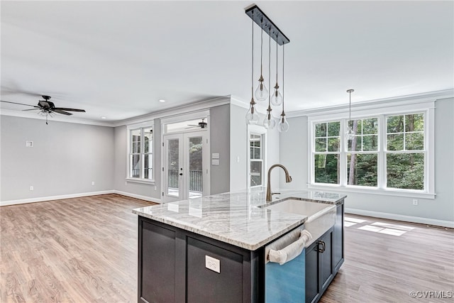 kitchen with ceiling fan with notable chandelier, light wood-type flooring, hanging light fixtures, and ornamental molding