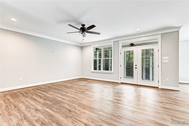 spare room with ornamental molding, light hardwood / wood-style floors, ceiling fan, and french doors