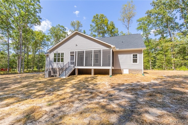 rear view of property featuring a sunroom and central air condition unit