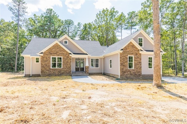 view of front of house featuring stone siding and board and batten siding