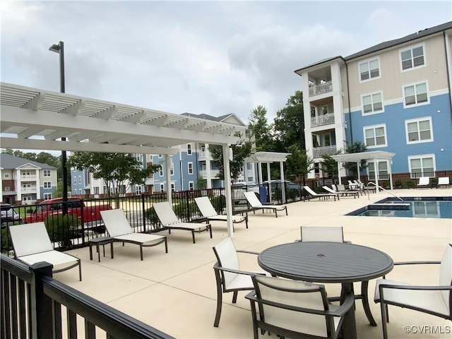 view of community with a patio area, fence, and a pergola