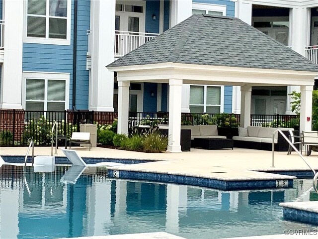 view of pool featuring outdoor lounge area, a gazebo, and a patio area