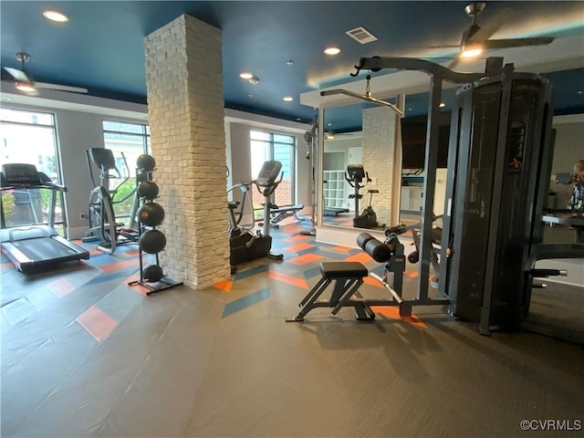 gym with decorative columns, visible vents, ceiling fan, and a wealth of natural light