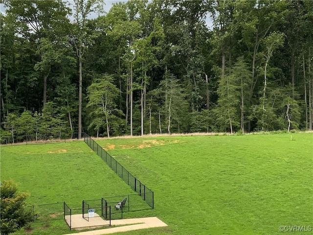 view of property's community with a yard and fence