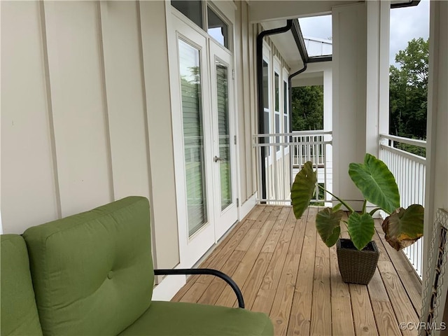 sunroom featuring french doors and a skylight