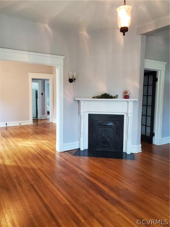 unfurnished living room with wood-type flooring