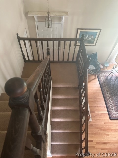 stairway with hardwood / wood-style flooring