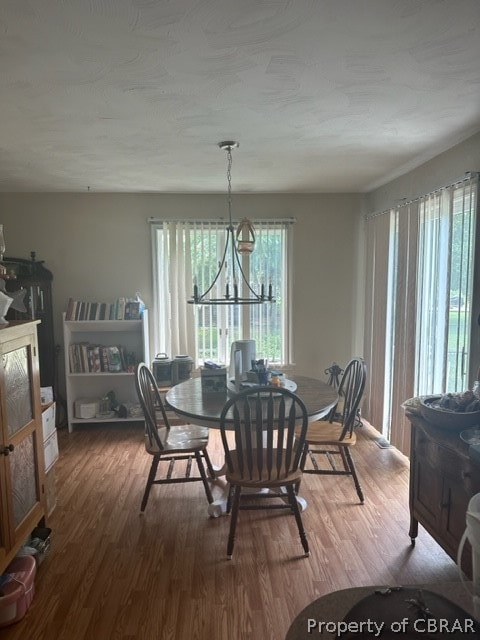 dining area featuring an inviting chandelier and hardwood / wood-style floors