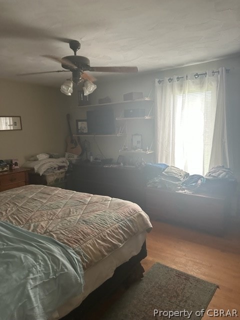 bedroom featuring wood-type flooring and ceiling fan