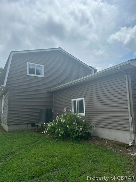 rear view of house with a yard and central AC unit