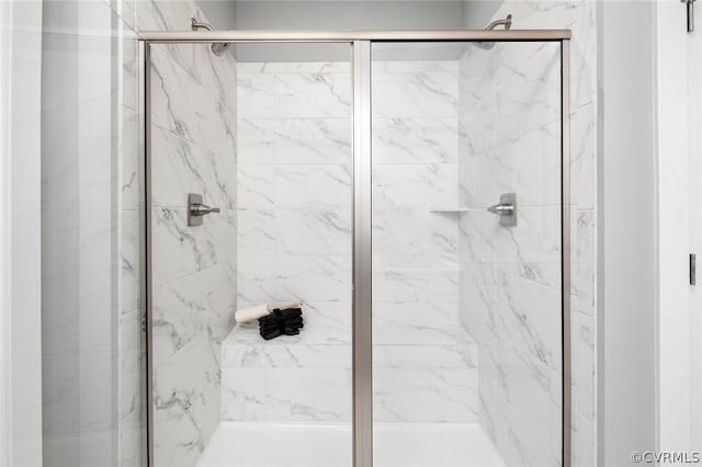 bathroom with a shower with shower door