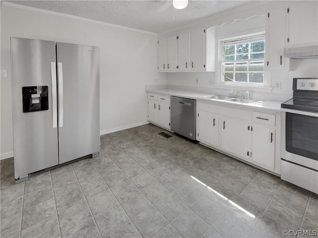 kitchen featuring stainless steel appliances, sink, white cabinets, and a textured ceiling