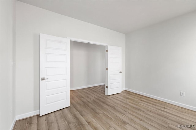 unfurnished bedroom featuring light wood-type flooring