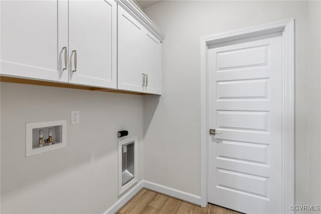 clothes washing area with washer hookup, electric dryer hookup, cabinets, and light hardwood / wood-style flooring