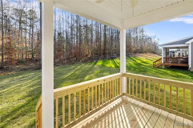 wooden deck featuring a yard