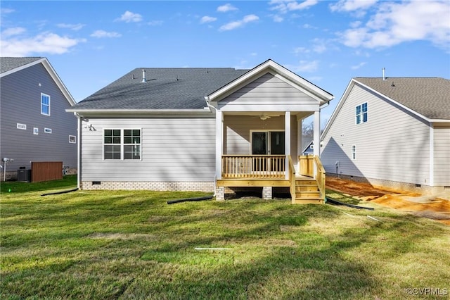 back of property with a lawn, ceiling fan, central AC unit, and a wooden deck