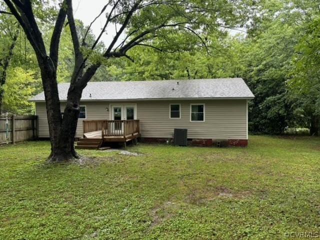 back of house with a lawn, a deck, fence, french doors, and central AC unit