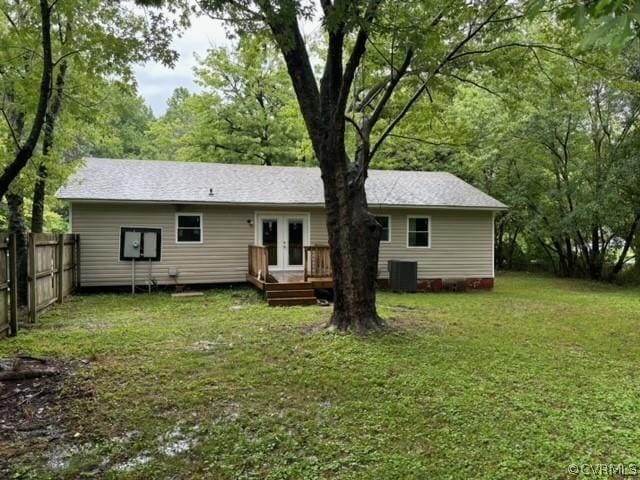 back of house featuring french doors, central AC, a yard, and fence