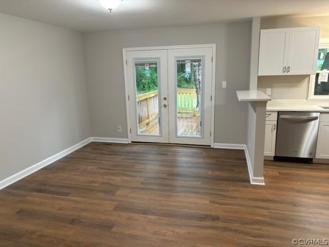 interior space with french doors, baseboards, and dark wood-style floors