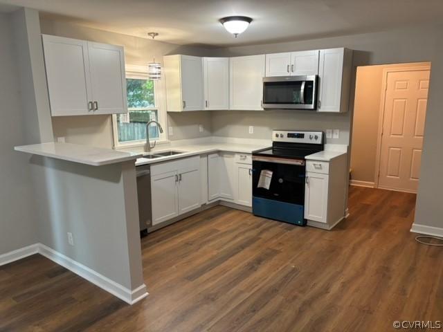 kitchen with appliances with stainless steel finishes, white cabinetry, and light countertops