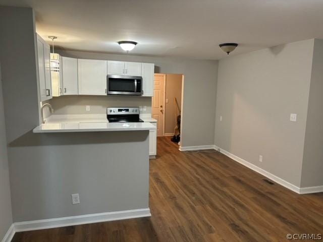 kitchen with stainless steel appliances, baseboards, white cabinets, and light countertops