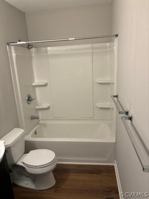 full bathroom with shower / bathing tub combination, toilet, wood finished floors, and vanity