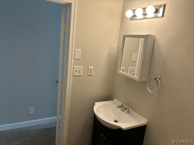 bathroom with vanity and baseboards