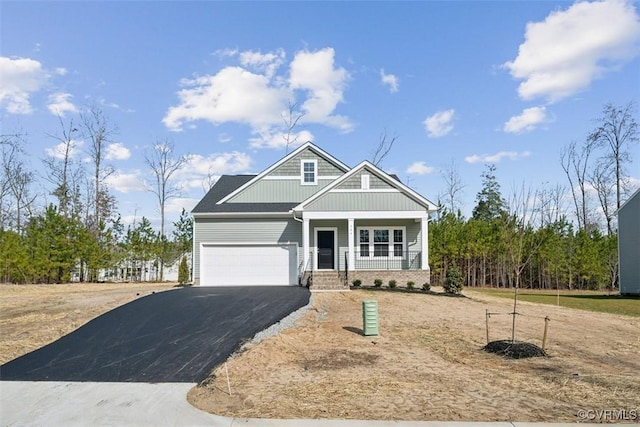 craftsman house featuring covered porch and a garage