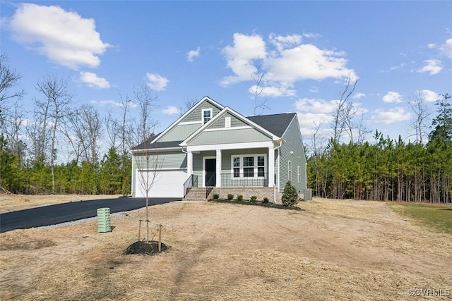 view of front of home featuring a garage and a porch