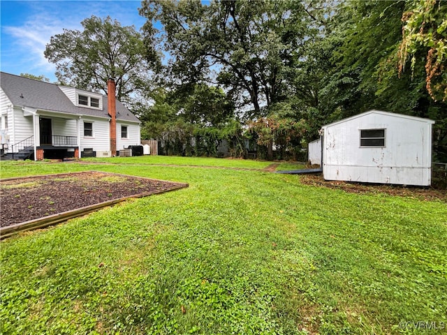 view of yard with a wooden deck and a shed