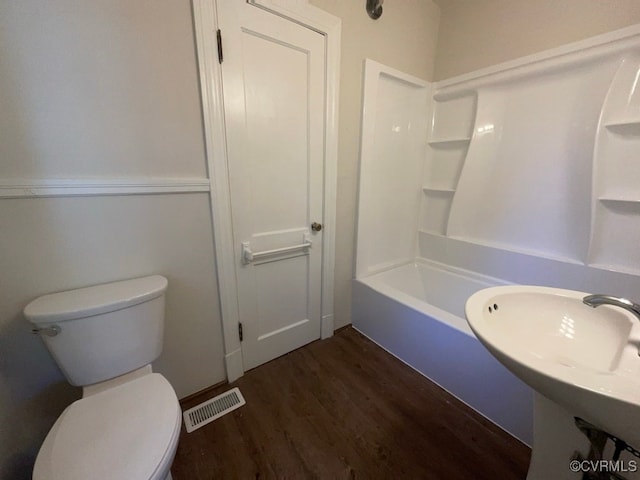 full bathroom with hardwood / wood-style floors, sink, toilet, and shower / bath combination