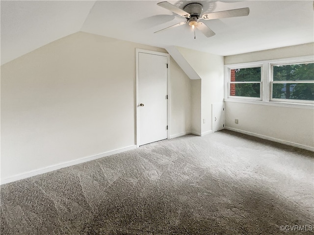 bonus room with light carpet, ceiling fan, and vaulted ceiling