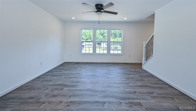 empty room featuring ceiling fan and dark hardwood / wood-style flooring