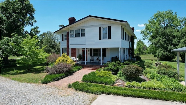 1501 Saxkey Rd, Drakes Branch, VA 23937 - view of front of house with a porch, a front yard, and a chimney