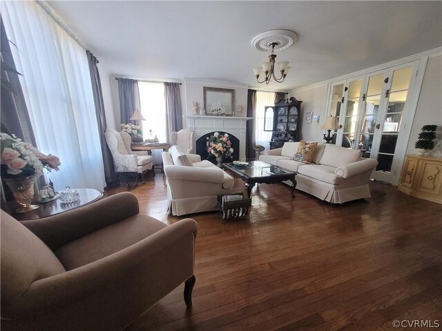 1501 Saxkey Rd, Drakes Branch, VA 23937 - living room featuring ornamental molding, a fireplace, wood finished floors, and a notable chandelier