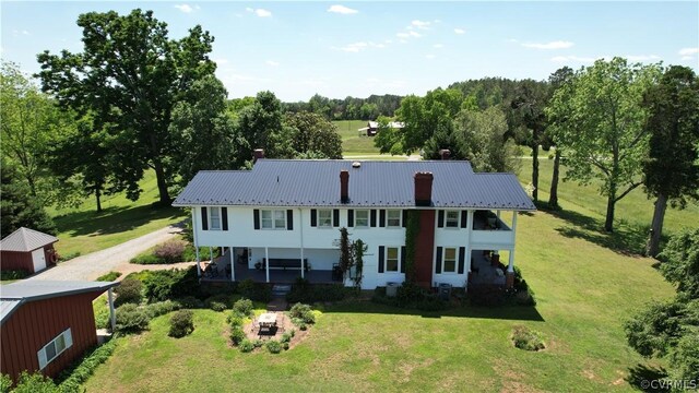 1501 Saxkey Rd, Drakes Branch, VA 23937 - exterior space with a chimney, metal roof, an outdoor structure, an outdoor fire pit, and a front lawn