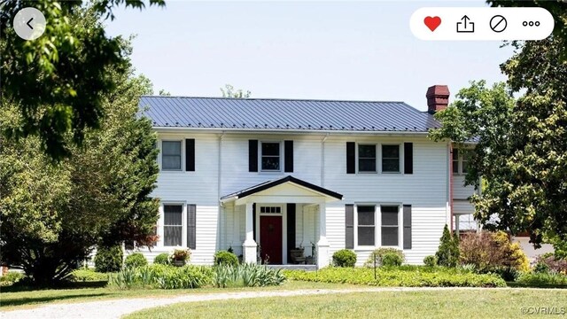 1501 Saxkey Rd, Drakes Branch, VA 23937 - colonial home with a chimney, metal roof, and a front yard